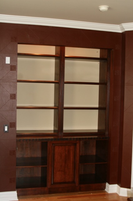 Dark-stained library built-in with adjustable shelves