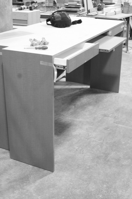 Desk with dovetailed drawers being fitted in the shop