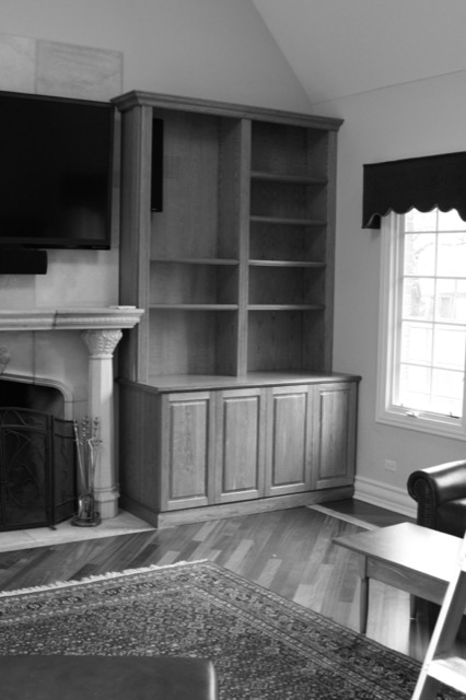 Built-in bookcase beside a fireplace