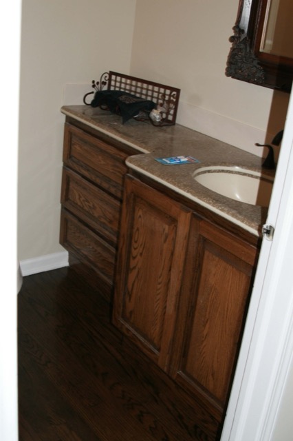 Oak bathroom vanity with stone countertop